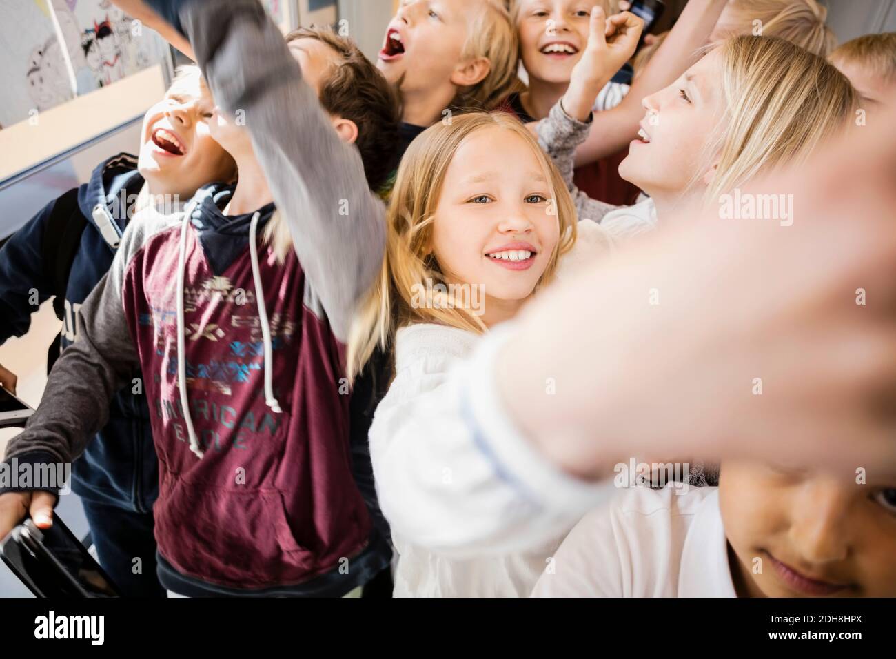 Vista ad alto angolo degli amici che giocano insieme nel corridoio a. scuola Foto Stock