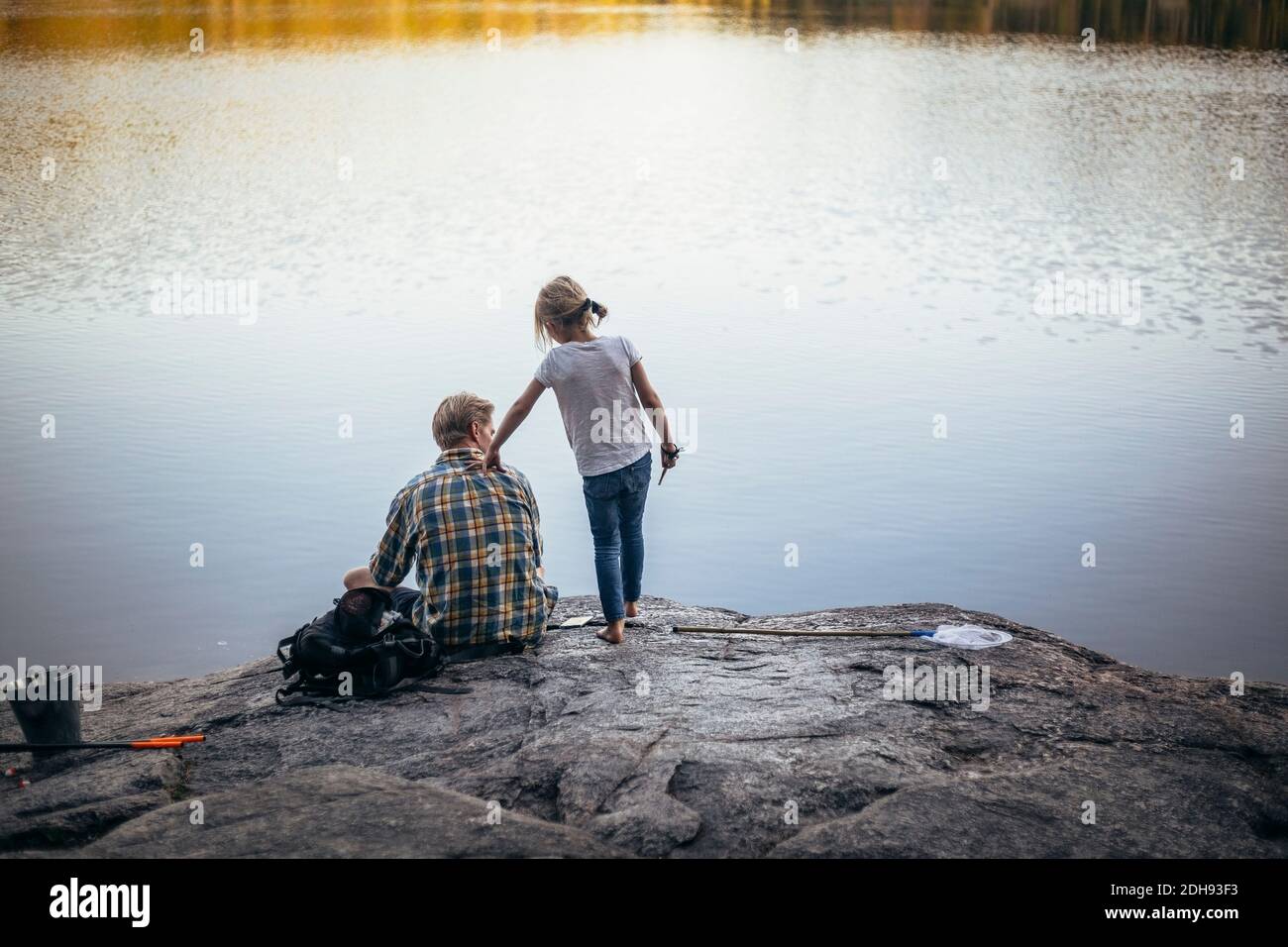 Vista posteriore di padre e figlia pesca al lago Foto Stock