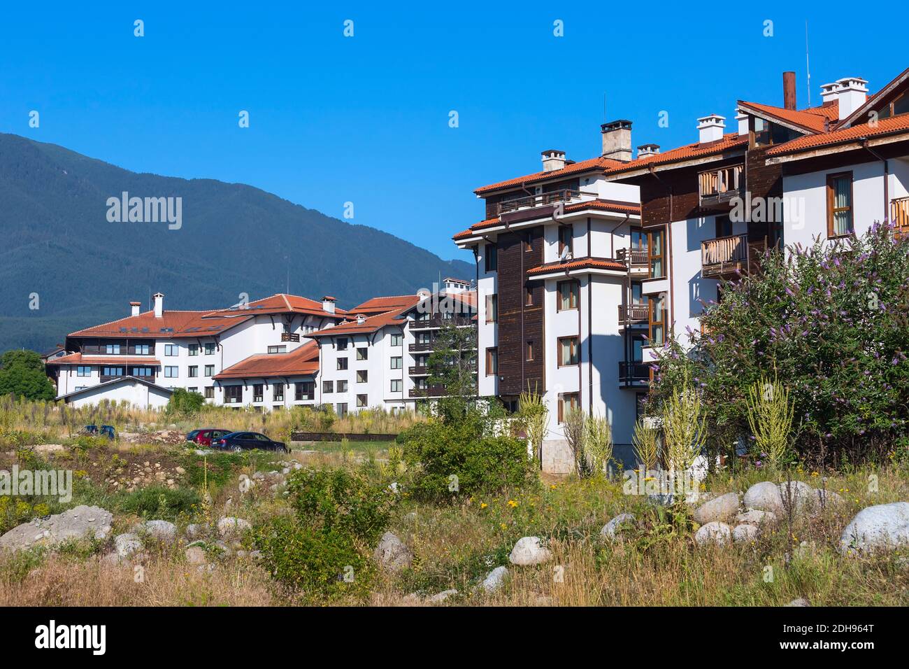 Case in legno chalet e panorama estivo montagne nella stazione sciistica bulgara Bansko, Bulgaria Foto Stock