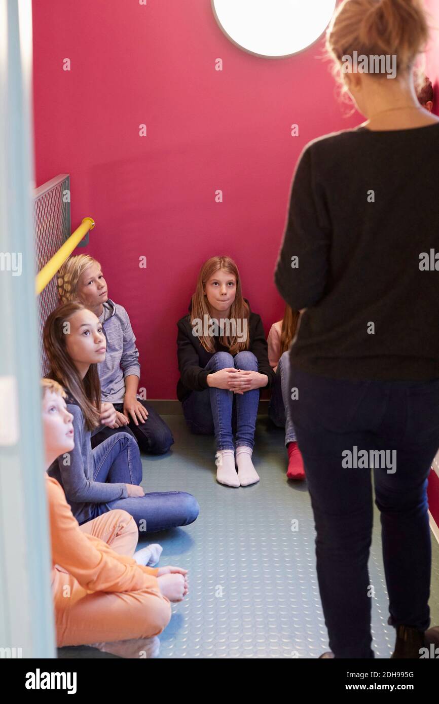 Giovani studenti superiori che guardano l'insegnante nella scuola media Foto Stock