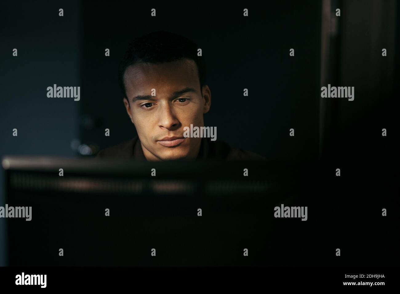 Primo piano di un uomo d'affari che utilizza il computer in ufficio di notte Foto Stock