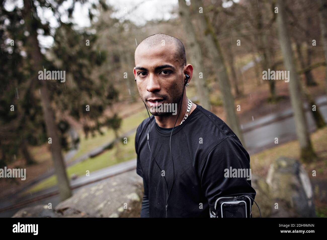 Ritratto di sicuro atleta maschile in piedi in foresta Foto Stock
