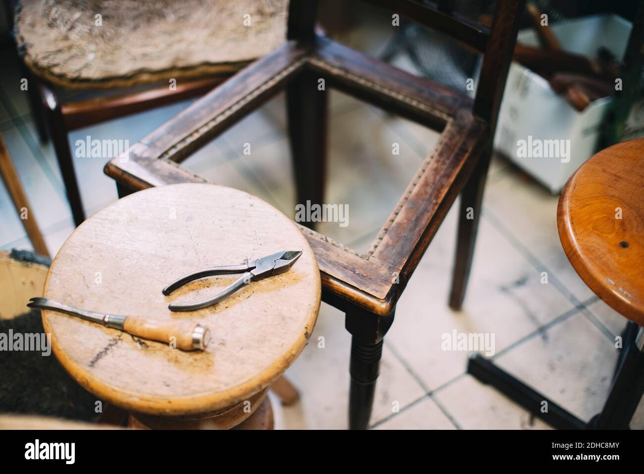 Vista ad angolo alto degli attrezzi manuali sul tavolo nella tappezzeria officina Foto Stock