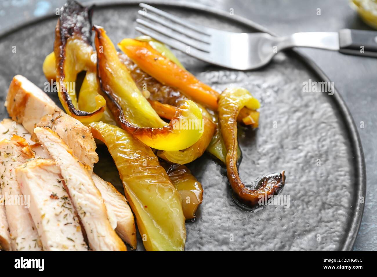 Pepe al forno con pollo e spezie su sfondo scuro Foto Stock