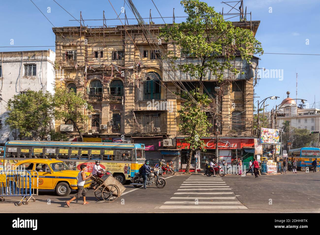 Mezzi di trasporto pubblico sulla strada della città indiana con il vecchio patrimonio Edifici a Esplanade Kolkata Foto Stock
