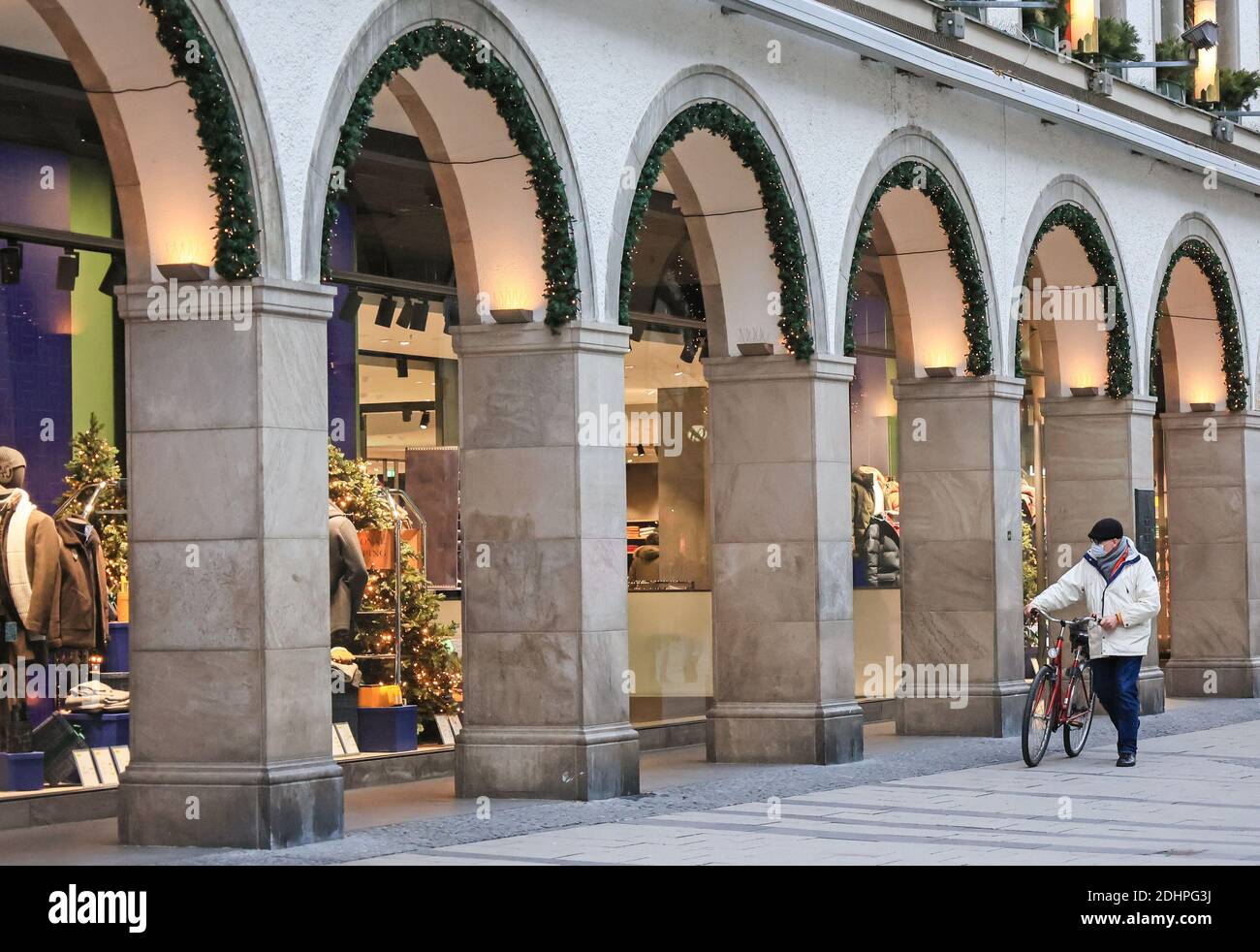 Monaco, Germania. 11 Dicembre 2020. Un pedone che indossa una maschera cammina davanti alle vetrine del negozio con una bicicletta a Monaco, Germania, 11 dicembre 2020. Le infezioni e le morti giornaliere COVID-19 hanno continuato ad arrampicarsi in Germania e hanno raggiunto nuovi massimi venerdì, secondo i dati del Robert Koch Institute (RKI). Credit: Philippe Ruiz/Xinhua/Alamy Live News Foto Stock