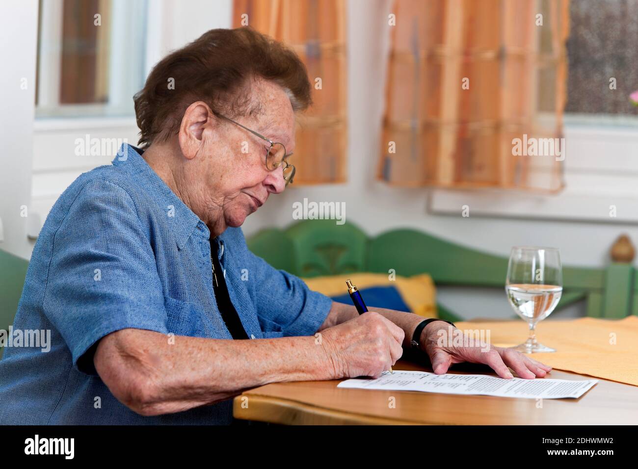 Eine alte Frau unterschreibt einen Vertrag, Senioren, Foto Stock