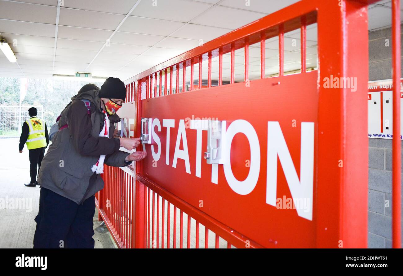 Crawley UK 12 dicembre 2020 - i tifosi sanitizzano le mani quando arrivano al loro ritorno a guardare il calcio oggi, dove un numero limitato sono stati ammessi durante la partita Sky Bet EFL League due tra Crawley Town e Barrow AFC al People's Pension Stadium - solo per uso editoriale. Nessuna merchandising. - per maggiori dettagli contatta Football Dataco : Credit Simon Dack TPI / Alamy Live News Foto Stock