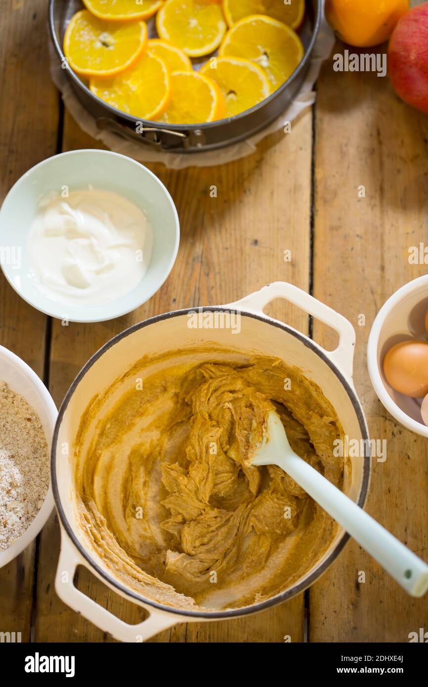 Preparare una torta di arancia e yogurt capovolta. Impastare con ingredienti diversi. Foto Stock