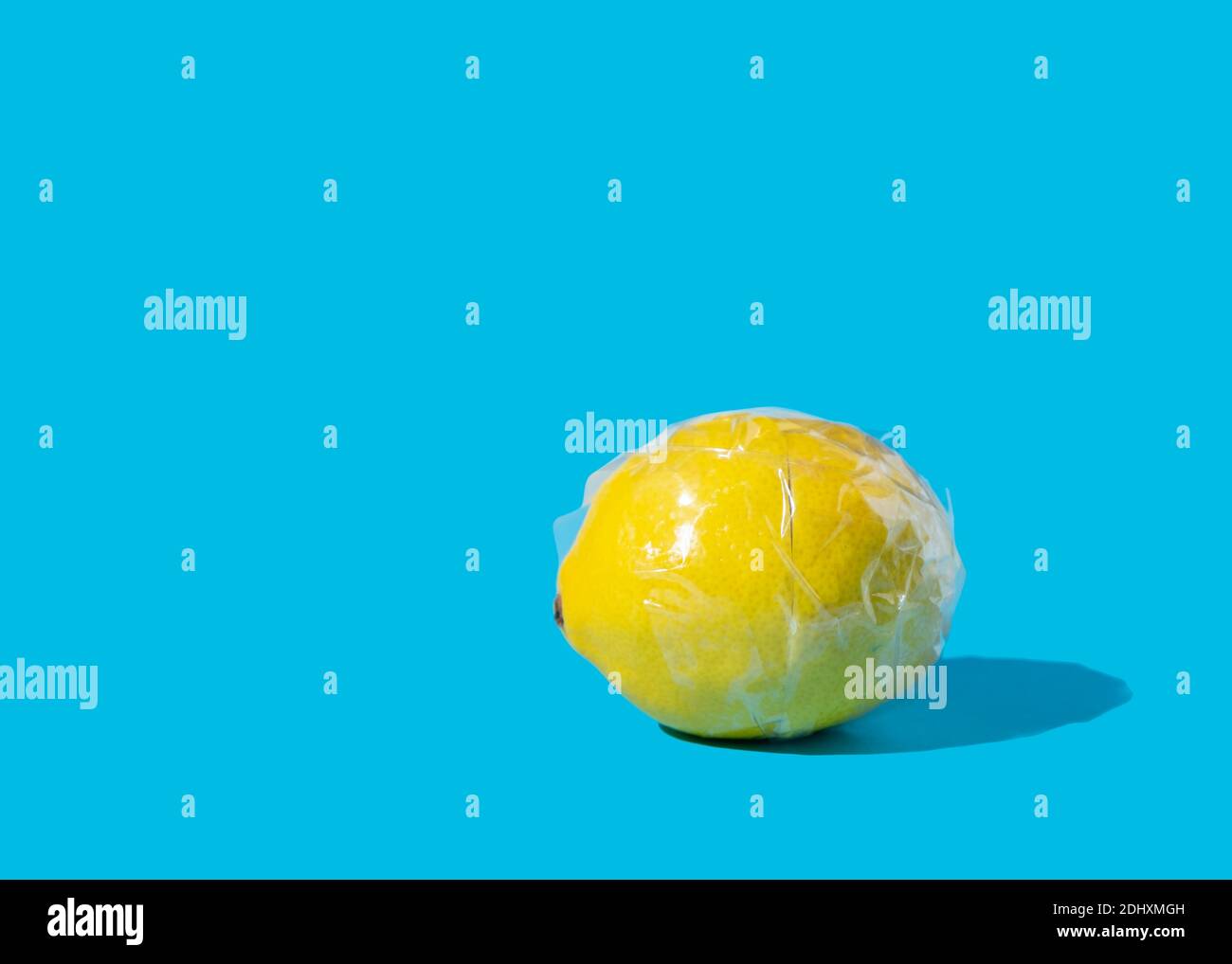 Limone giallo avvolto in nastro di plastica trasparente Foto Stock