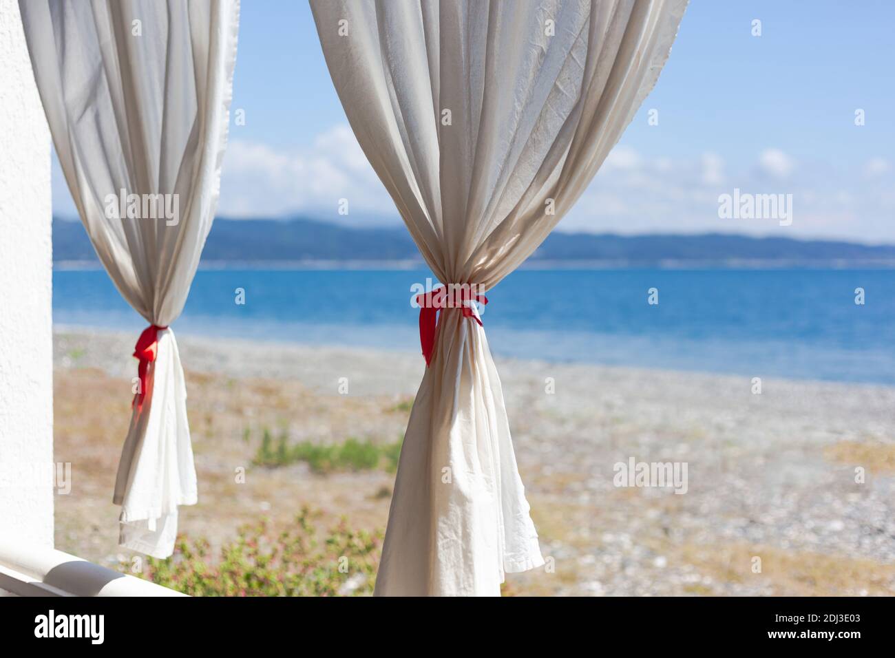 Tende bianche contro il mare Foto Stock