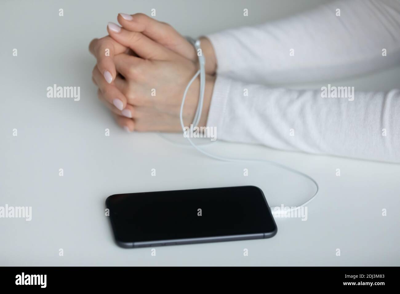 Primo piano giovane donna con le mani avvolte in cavi Foto Stock