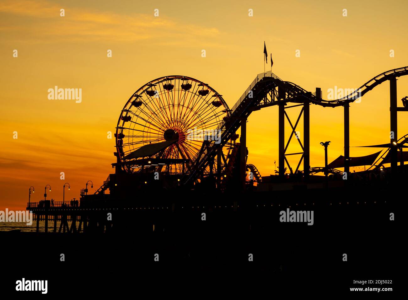 Silhouette al tramonto con ruota grande e montagne russe. Santa Monica Beach Pier, Santa Monica, Los Angeles, California, Stati Uniti d'America Foto Stock