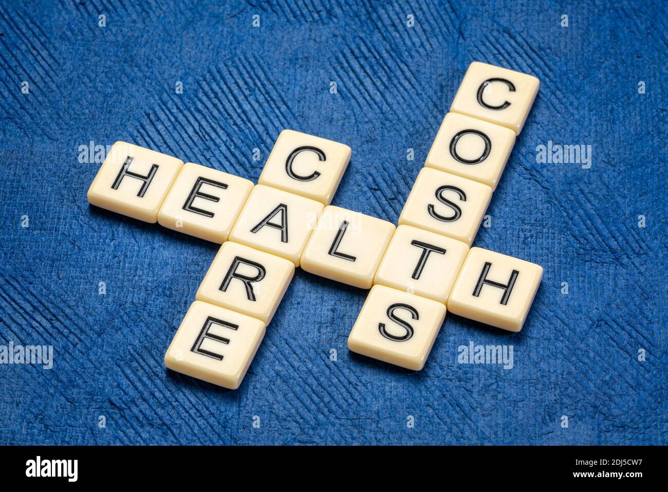 l'assistenza sanitaria costa crossword in piastrelle di lettera avorio contro carta testurizzata fatta a mano, l'assistenza sanitaria e il concetto di benessere Foto Stock