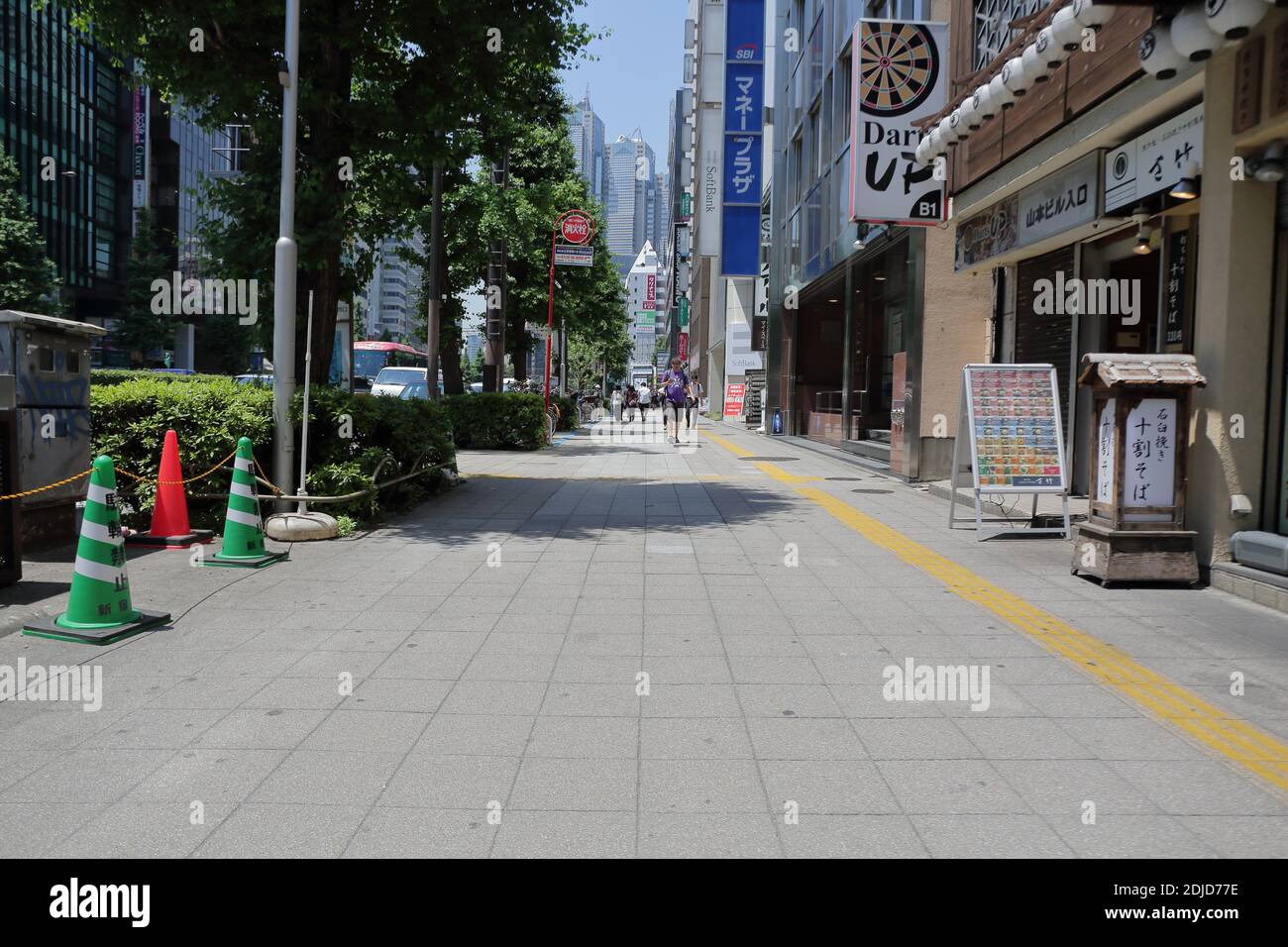 Il paesaggio urbano con alcune persone che camminano per strada a Shinjuku, Giappone Foto Stock