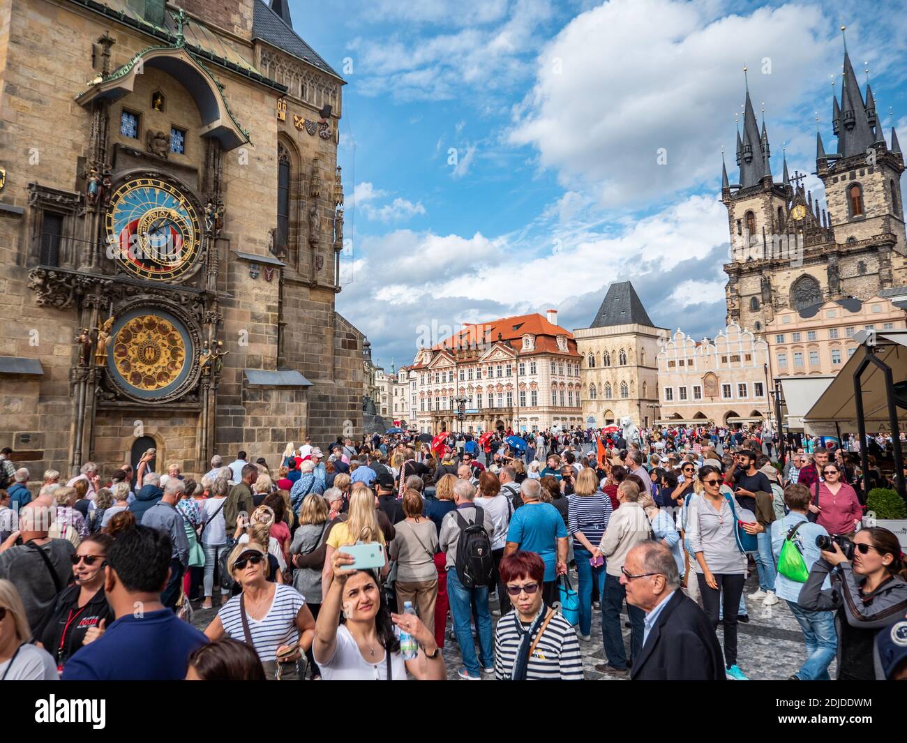 Turisti di Praga. Una trafficata Piazza della Citta' Vecchia nel centro di Praga con l'orologio astronomico e i punti di riferimento della Chiesa di Tyn in vista. Foto Stock