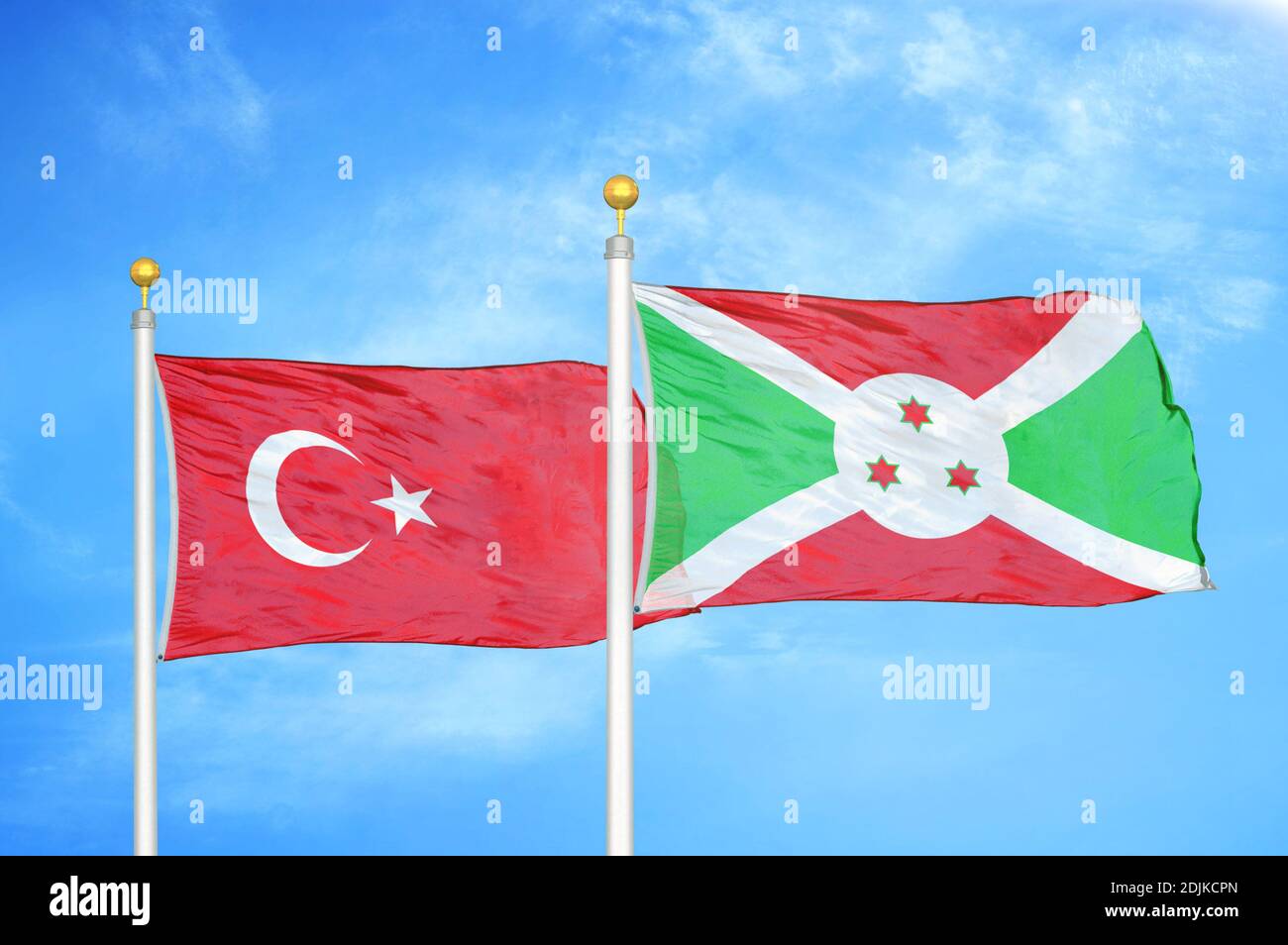 Turchia e Burundi due bandiere su palchi e blu nuvoloso cielo Foto Stock