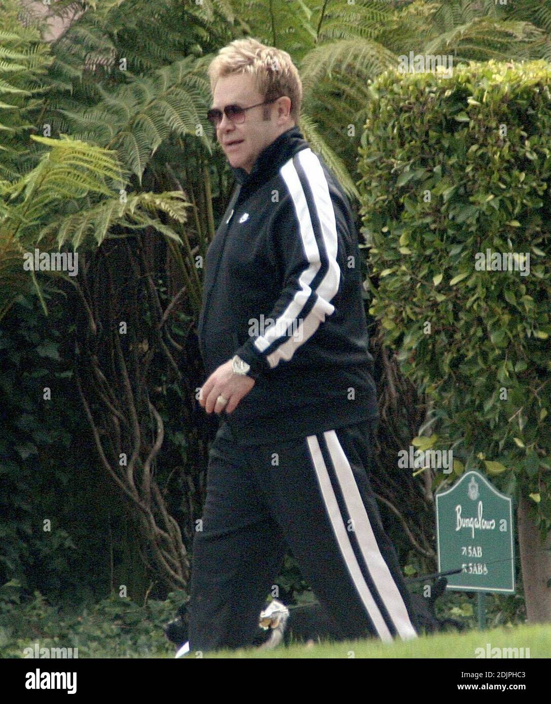 Esclusiva!! Elton John lascia il Beverly Hills Hotel a cinque stelle con un entourage e il suo amato cane. Il cantante stout ha portato un vestito da jogging, ma non è stato visto esercitarsi. 9/22/06 Foto Stock