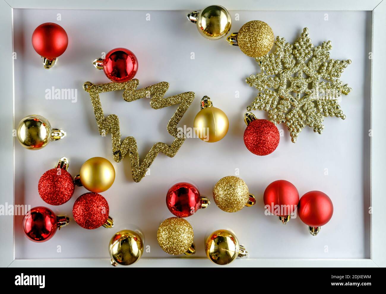 High angle view of red and golden Christmas decoration on white background Foto Stock