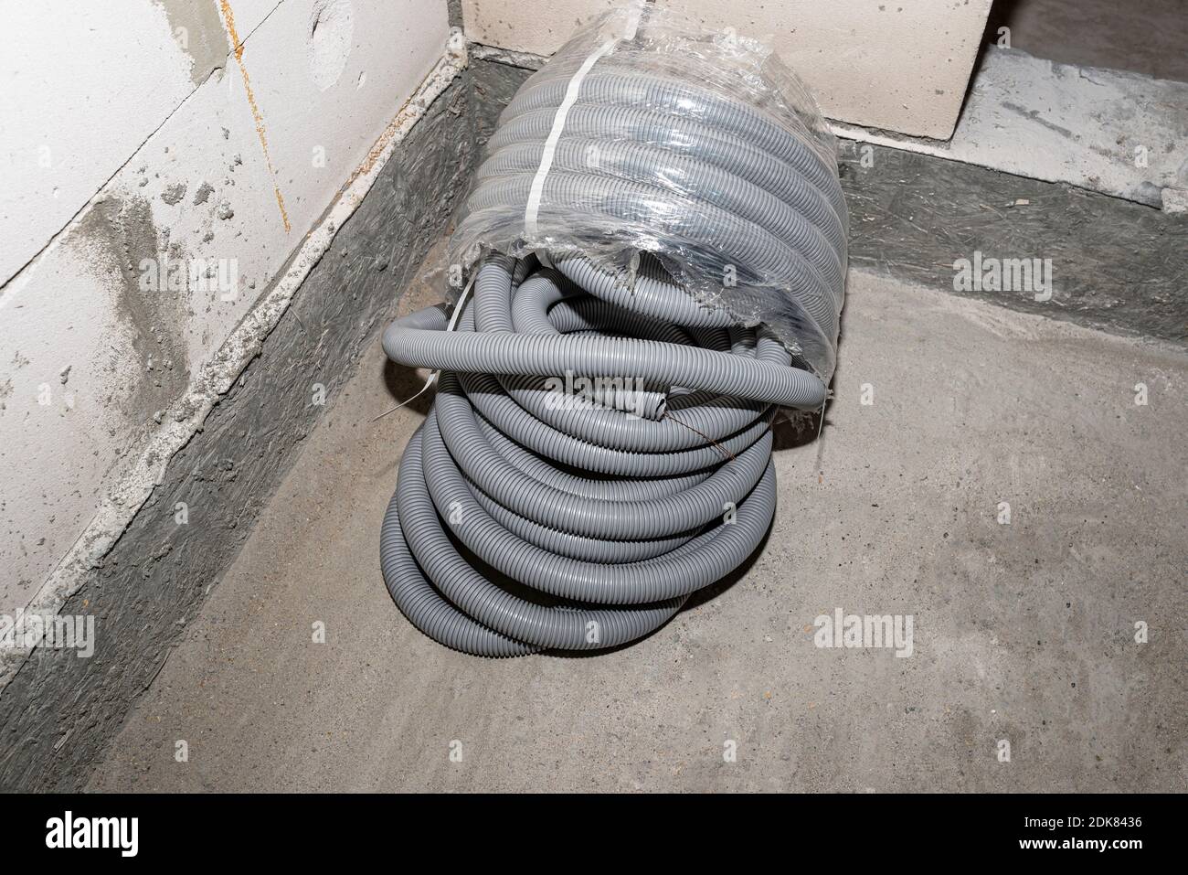 Tubo corrugato in PVC per fili elettrici, parzialmente disimballato,  giacente sul pavimento nella casa Foto stock - Alamy