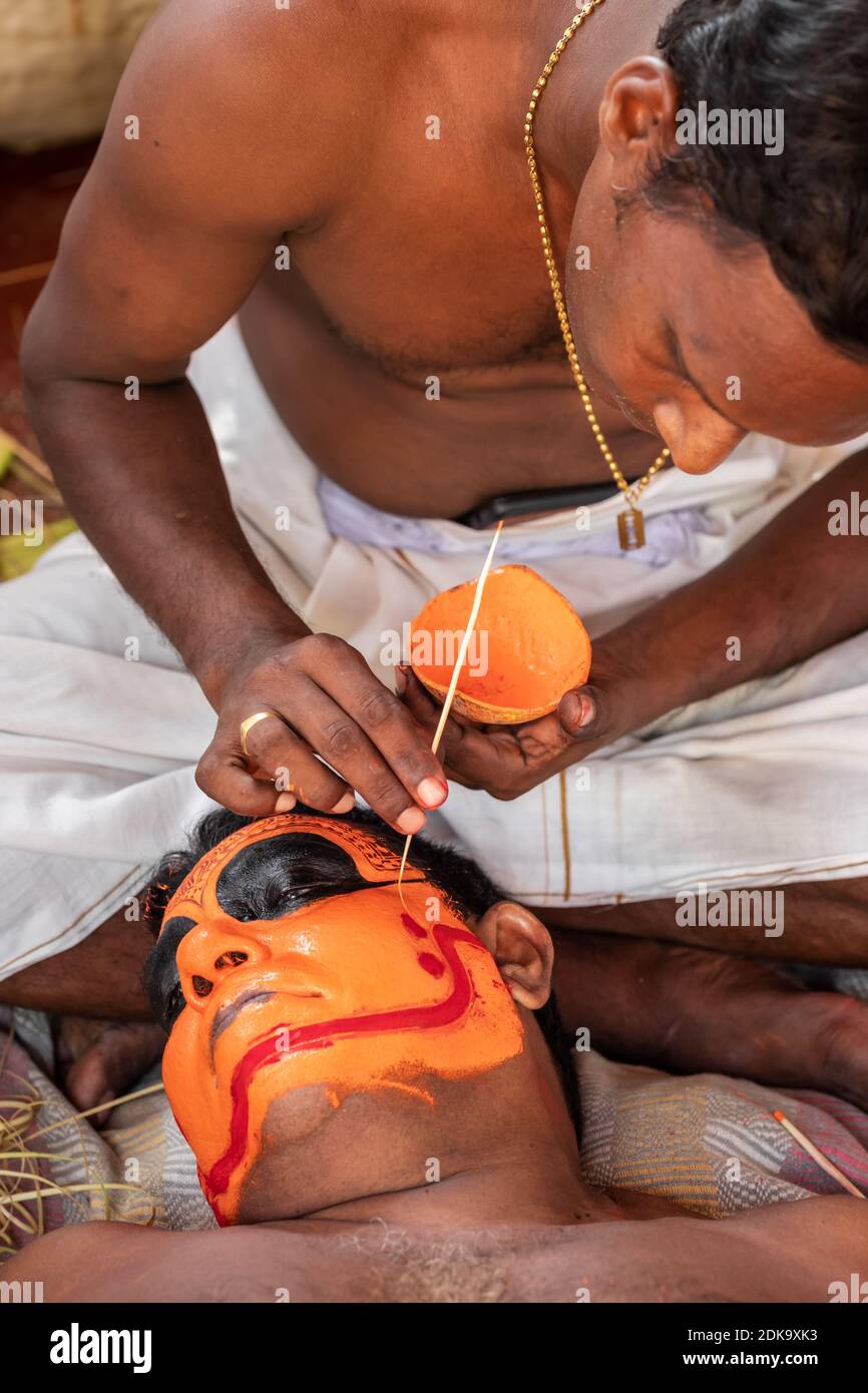 Il prete indù si adduca per l'esecutore di Theyyam durante il tempio festival Foto Stock