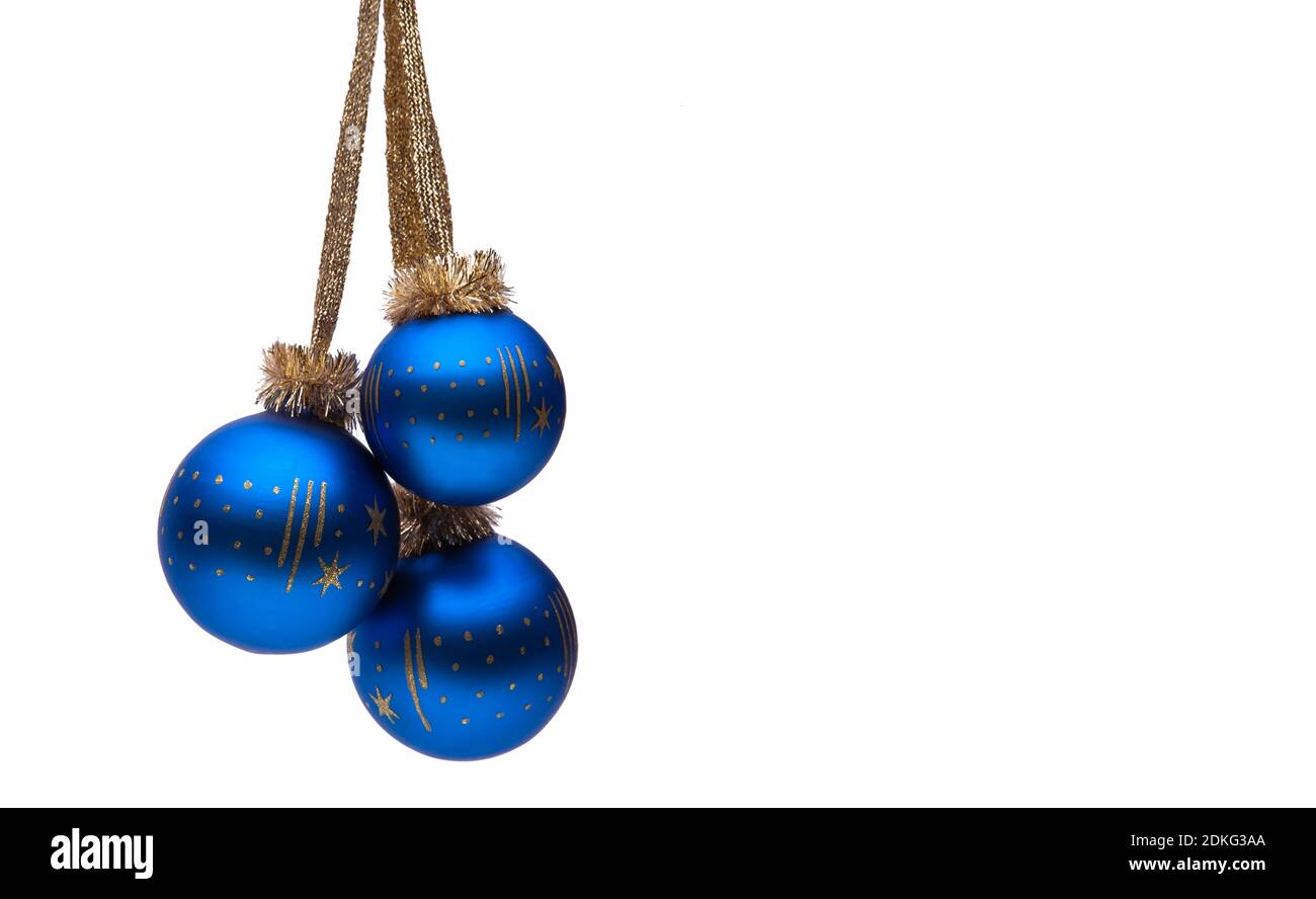 Three blue Christmas balls against a white background Foto Stock