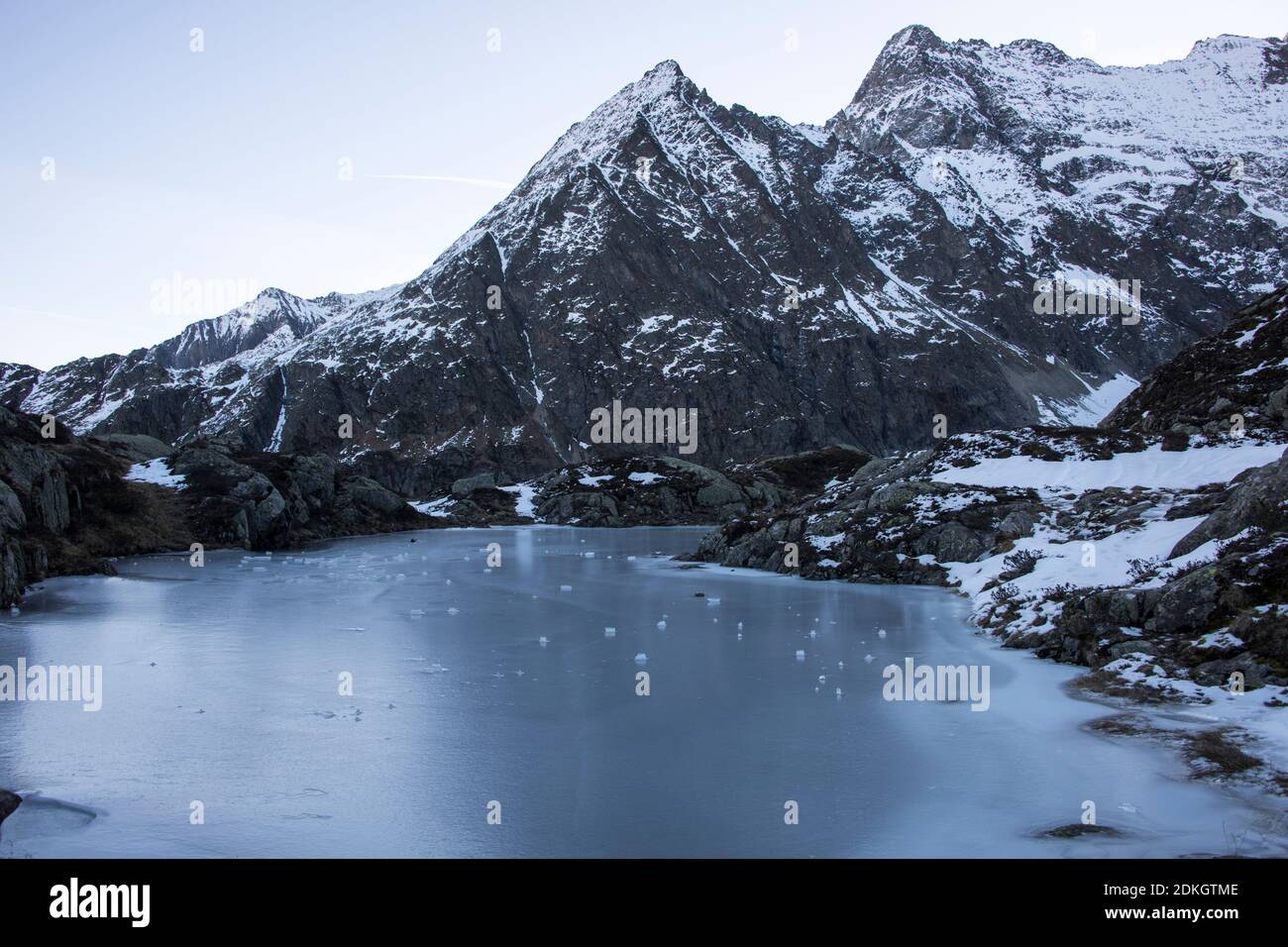 lago di montagna ghiacciato dopo una notte fredda Foto Stock
