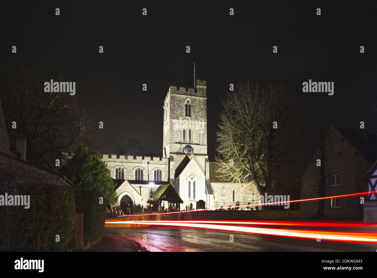 St Mary's Church, Felmersham, Bedfordshire, Regno Unito - percorsi di luce in auto accanto alla chiesa del villaggio illuminata per Natale e Capodanno Foto Stock