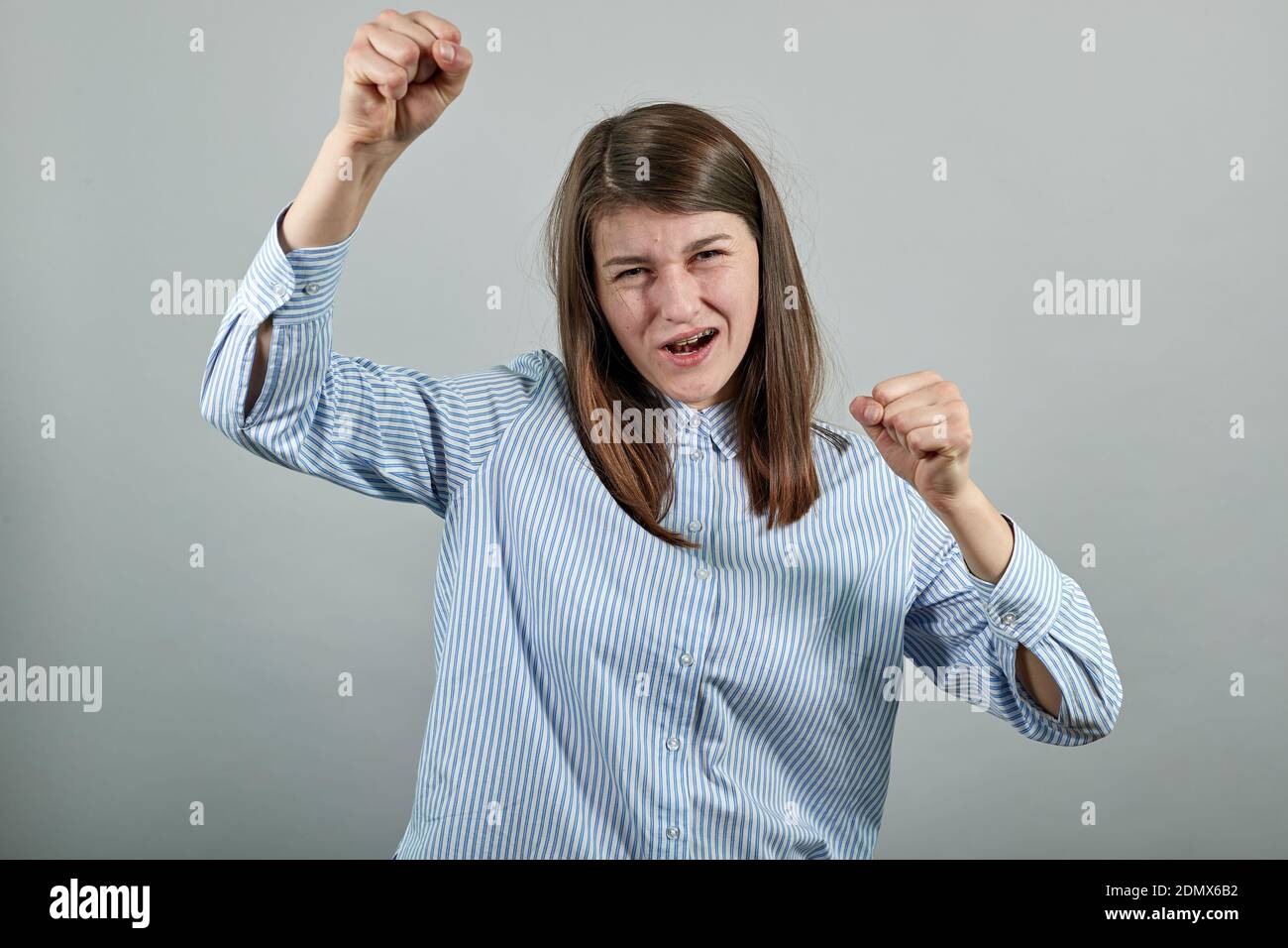 Balli felici, fare onda, divertirsi, ascoltare musica, sorridere. Mani agitanti graziate. Balli, salta, gioisce, ride. Braccia, femmina bella giovane attraente sensazione emozionale di salto eccitato Foto Stock