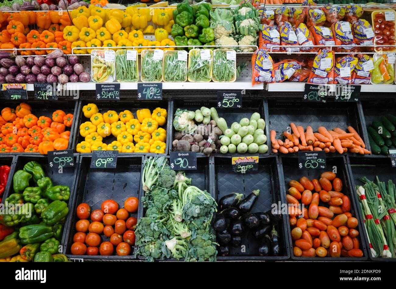Stand con verdure con i prezzi in minimarket. Grande varietà di verdure al coperto nel supermercato della drogheria. Mendoza, Argentina Foto Stock