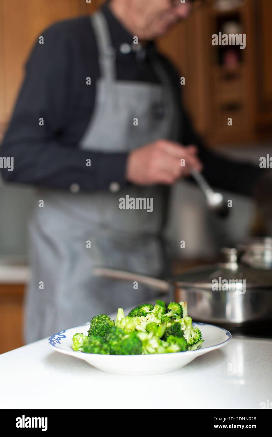 Uomo anziano che cucina cibo sano Foto Stock
