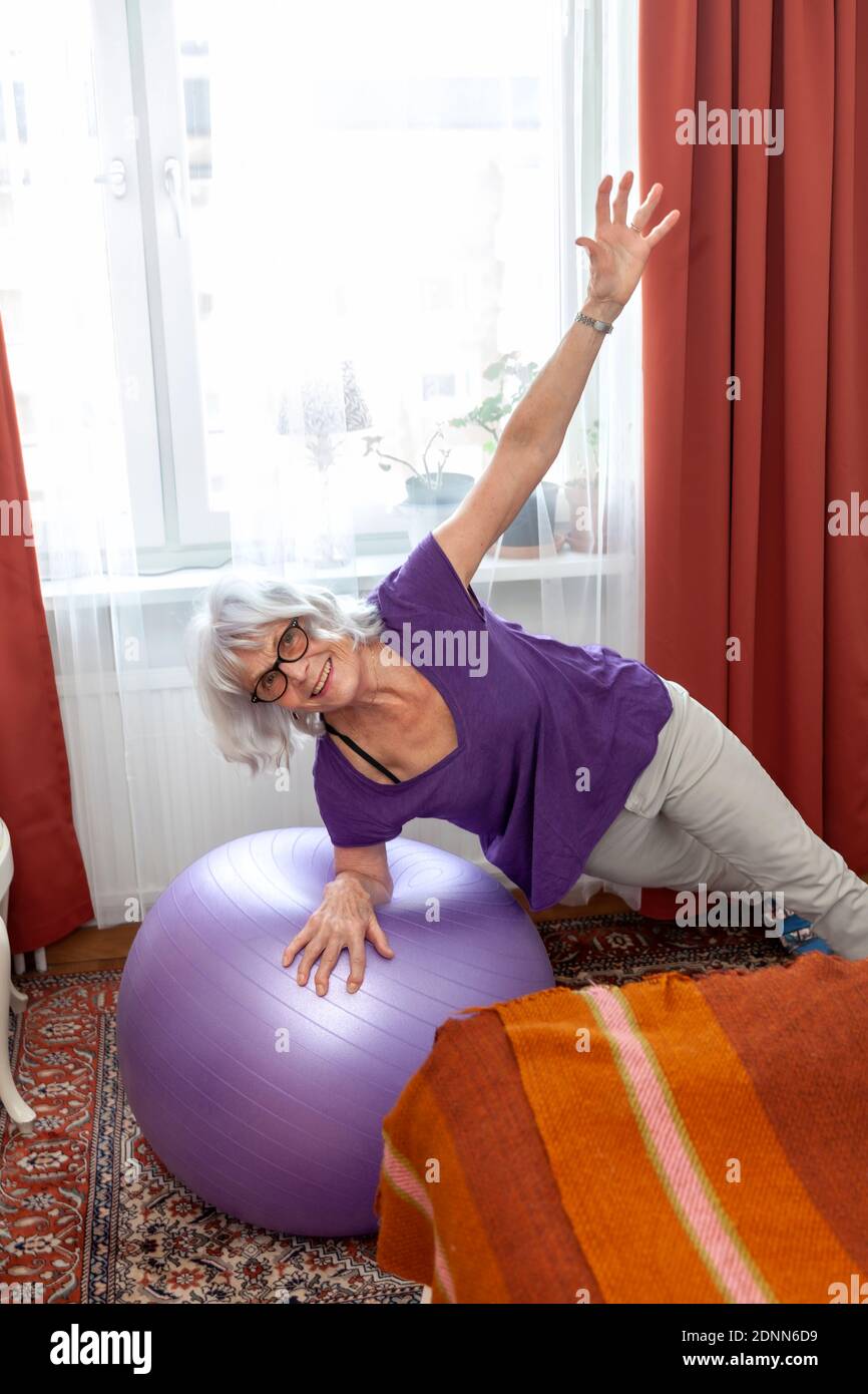 Senior donna esercizio con palla fitness Foto Stock