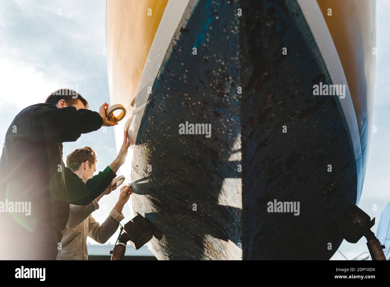 Uomo adesivo nastro di mascheratura sulla barca Foto Stock