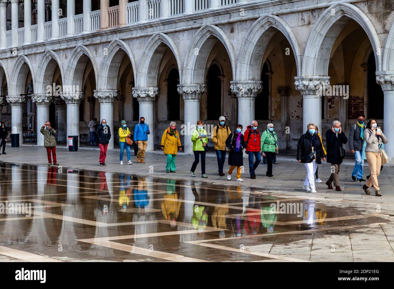 Un gruppo turistico in Piazza San Marco durante l'acqua alta (alta Tide), Venezia, Italia. Foto Stock