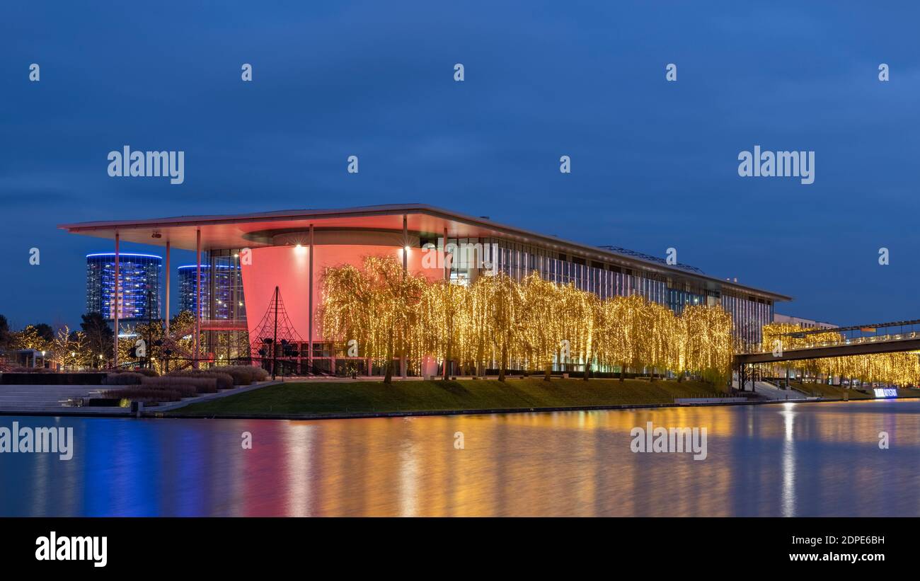 Volkswagen Autostadt e lo stabilimento automobilistico sono importanti punti di riferimento di Wolfsburg. Entrambi sono splendidamente illuminati per la stagione delle vacanze. Foto Stock