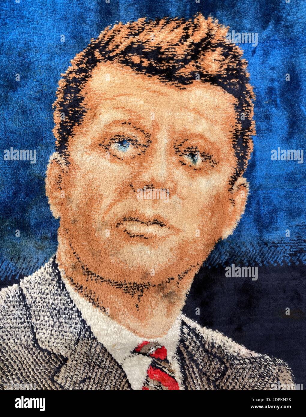 Un ritratto di John F Kennedy il 35° presidente degli Stati Uniti da una coperta intrecciata. Foto Stock