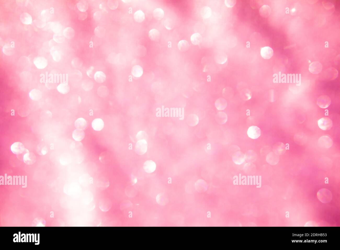 astratto rosa cerchi bokeh festivo glitter sfondo scuro Foto Stock