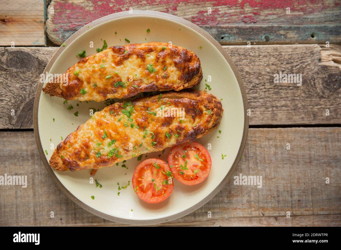 Un esempio fatto in casa di raebit gallese, talvolta chiamato coniglio gallese, cotto con formaggio Cheddar maturo e guarnito con prezzemolo. È spesso aromatizzato Foto Stock