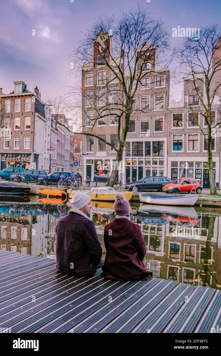 I canali olandesi di Amsterdam, coppie, visitano i canali olandesi durante  il viaggio in città ad Amsterdam, uomini e donne in viaggio in città ad  Amsterdam, Paesi Bassi. Europa Foto stock -