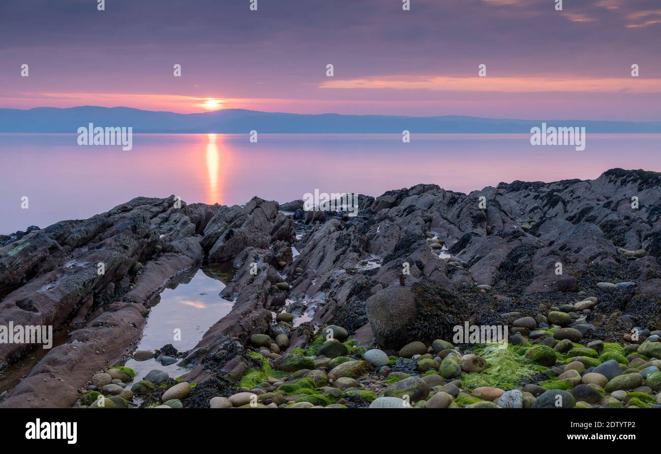 Tramonto colorato sull'isola di Arran lungo la costa occidentale della Scozia, Regno Unito. Foto Stock
