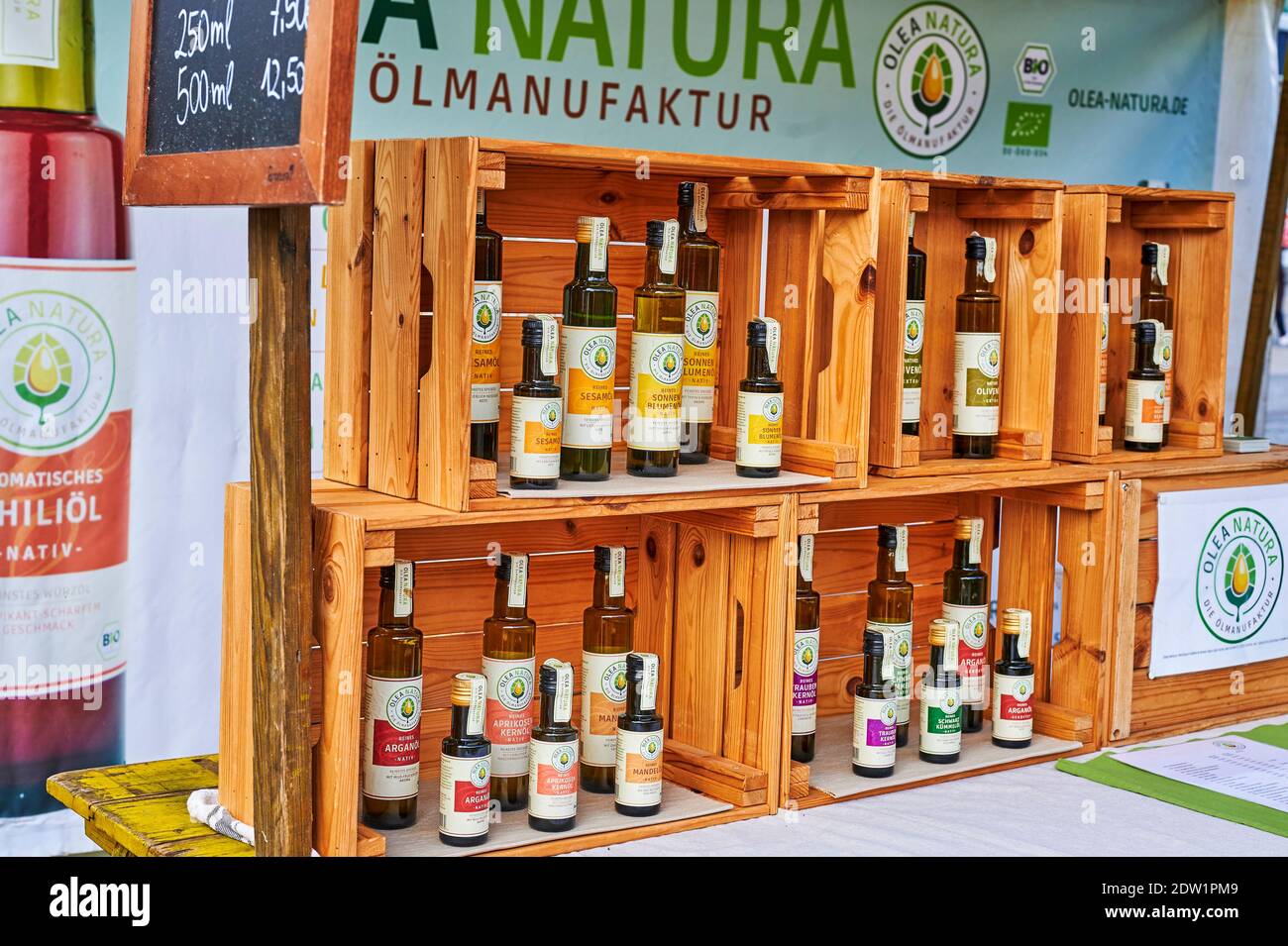 Berlino, Germania - 19 marzo 2020: Una bancarella del mercato del legno che vende bottiglie di vari oli commestibili. Foto Stock