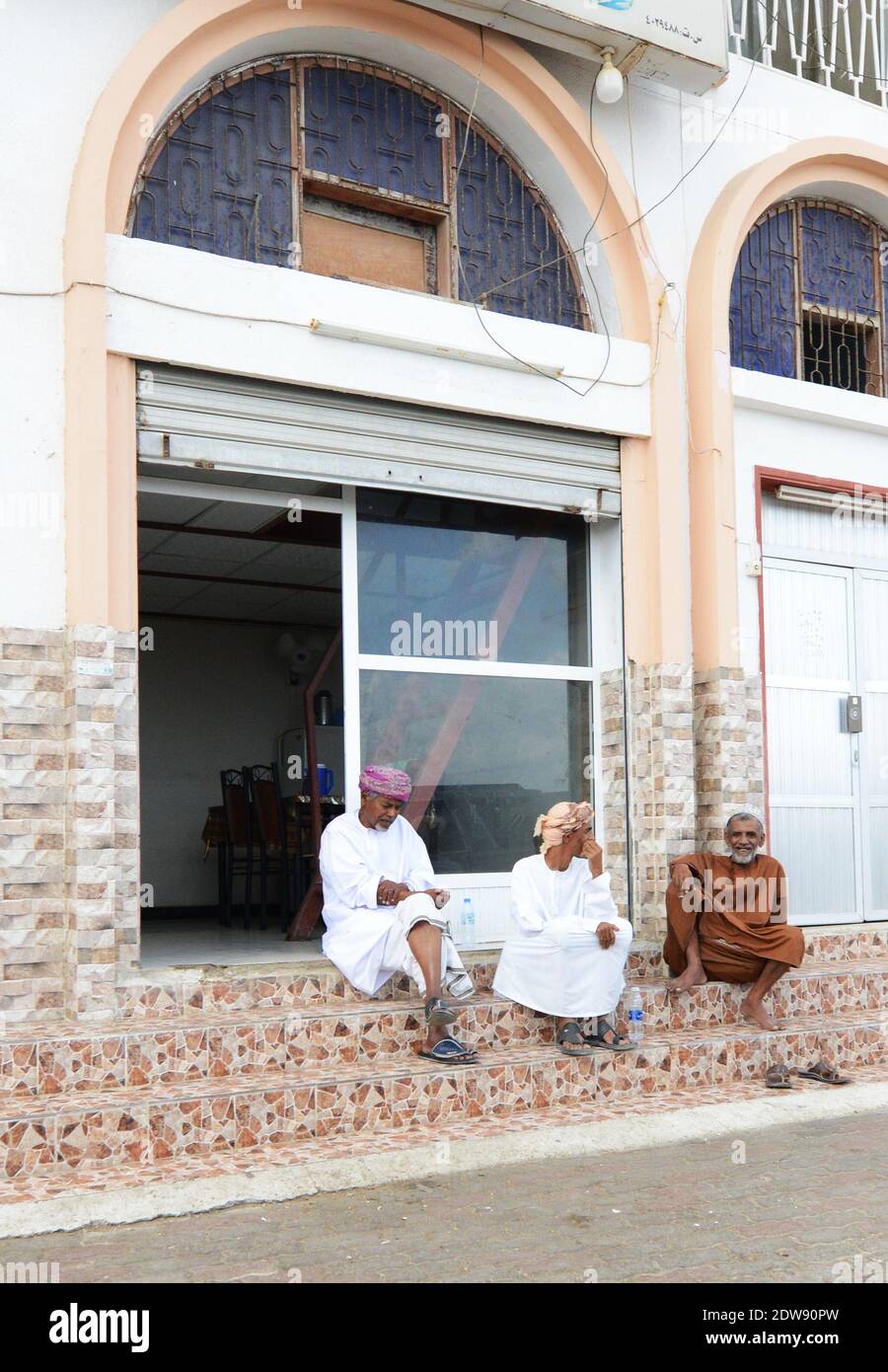 Uomini Omani che socializzano nel centro di sur, Oman. Foto Stock