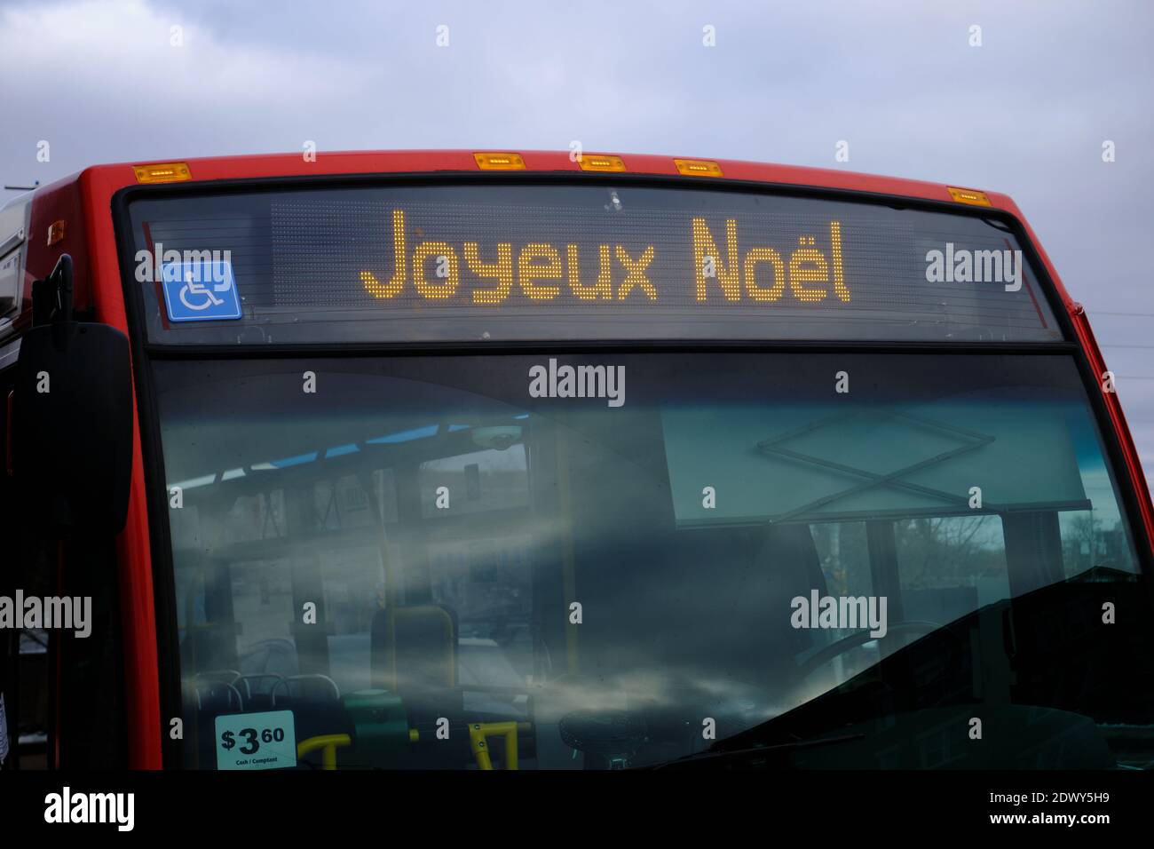 Ottawa, Ontario. Vicino alla parte anteriore dell'autobus cittadino con un augurio di buon Natale in francese sulla segnaletica anteriore. Foto Stock