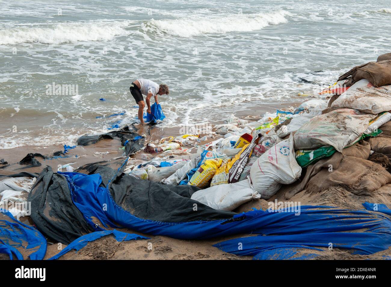 AUROVILLE, INDIA - 2020 dicembre: Pulire giorno per rimuovere la plastica a sinistra sulla spiaggia come protezione contro l'erosione del mare Foto Stock