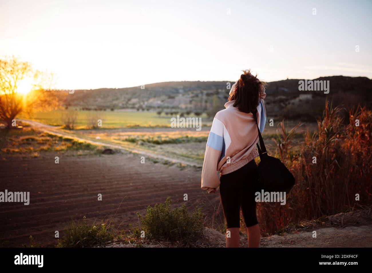 Madrid, Spagna. Atleta femminile che cammina sul campo dopo l'allenamento al tramonto. Foto Stock