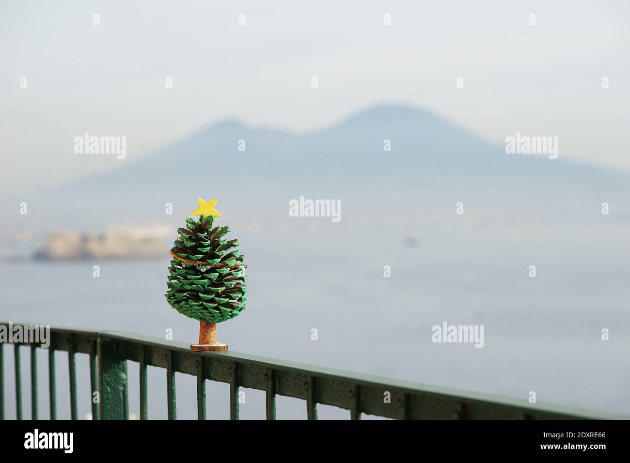 Albero di natale in miniatura - come decorazione fatta di cono di pino Sullo sfondo del Vesuvio Foto Stock