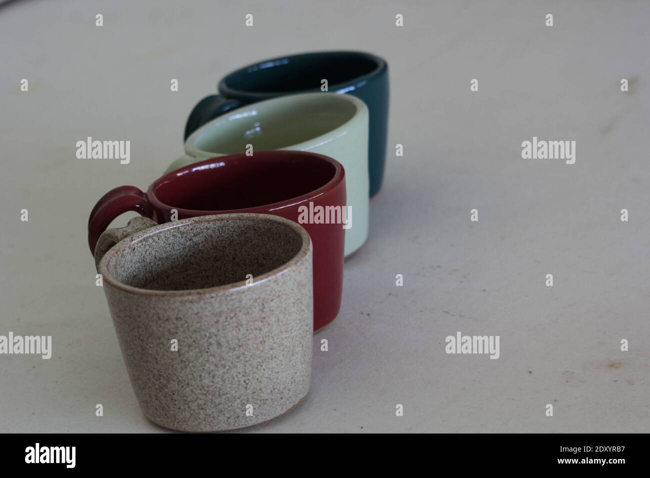 Un primo piano di tazze in ceramica su sfondo grigio Foto Stock