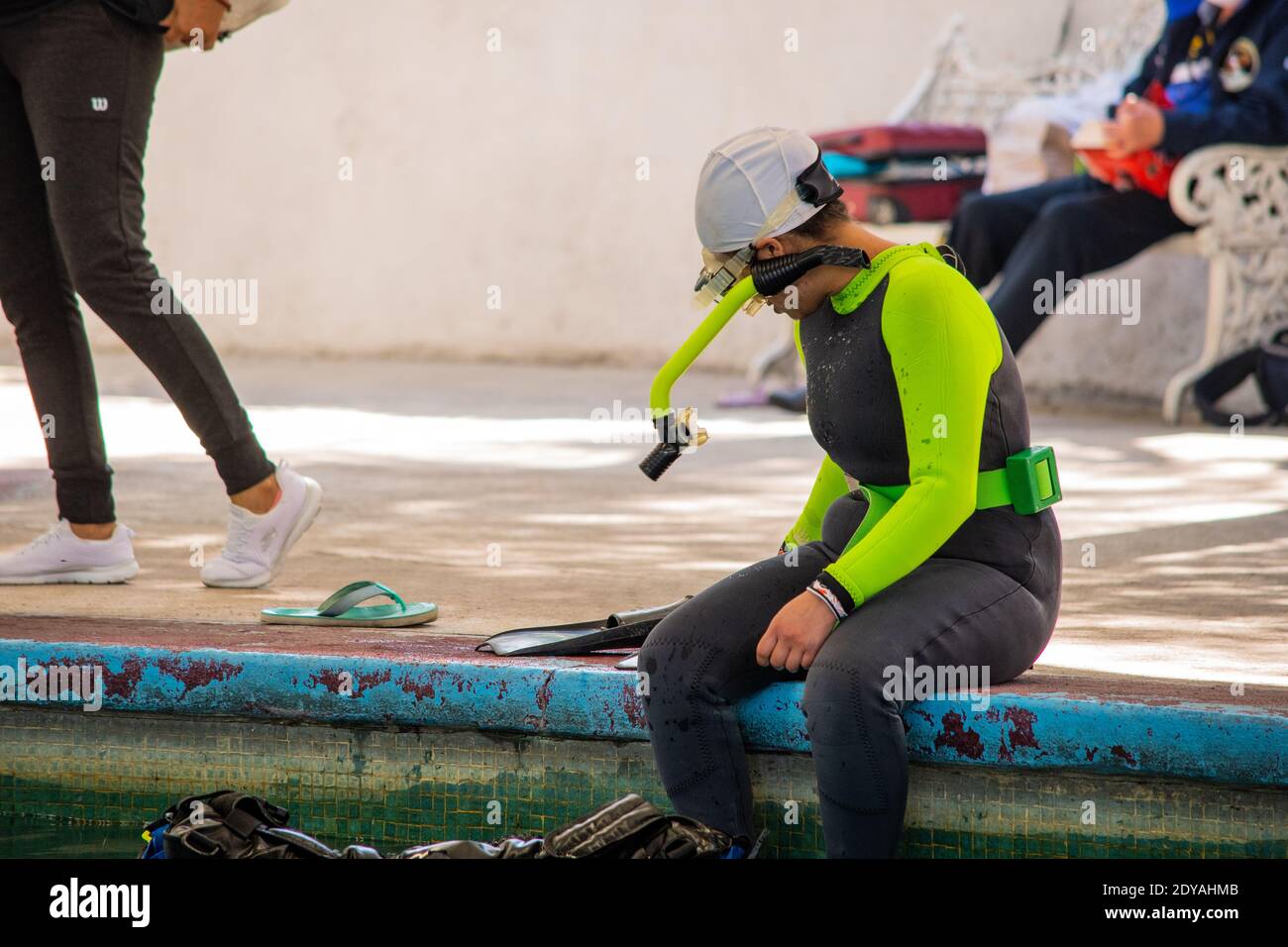 insegnante di immersione che riposa sul bordo della piscina dopo la sua classe Foto Stock