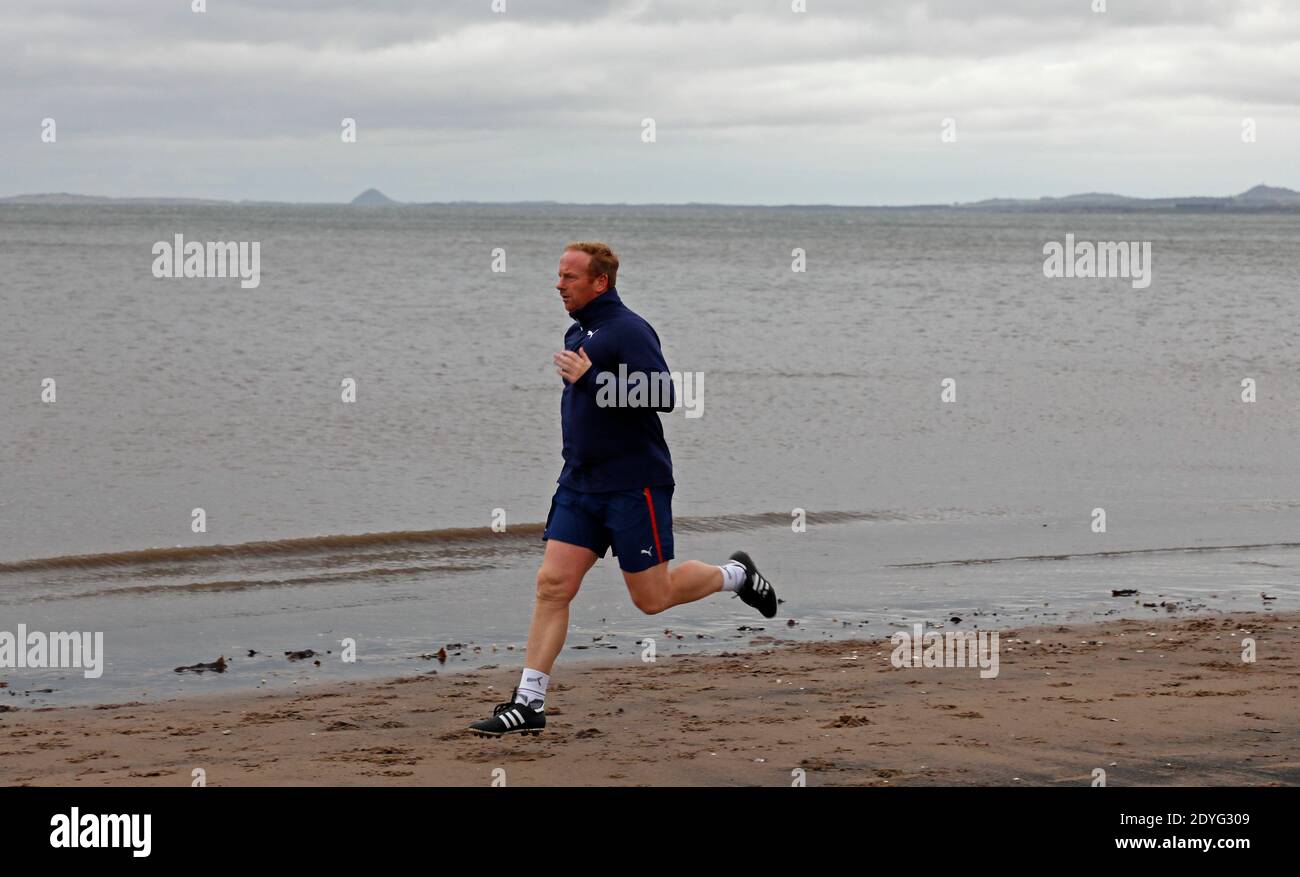 Portobello, Edimburgo, Scozia, Regno Unito. 26 dicembre 2020. L'esercizio all'aperto è stato consigliato questa mattina sulla BBC dal Prof. Devi Sridhar, nella foto: Le persone che si allenano al mare anche se fa freddo il giorno di Santo Stefano prima della pioggia fissata alle 11. Temperatura di 5 gradi centigradi sensazione reale -2 gradi. Portobello Beach è attualmente raccomandato nei primi dieci minuti di George Clooney ultimo film Midnight Sky, 'c'è un posto chiamato Portobello Beach ... È così bello, dovresti andarci appena al largo della costa vicino al Credit di Edimburgo: Arch White/Alamy Live News. Foto Stock