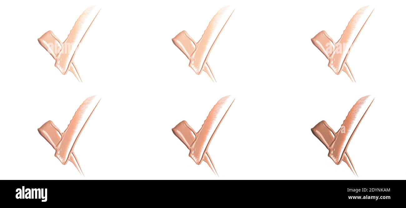 Sfumature di fondazione su sfondo bianco. Closeup di diversi toni di base liquida, composizione del prodotto. . Foto di alta qualità Foto Stock